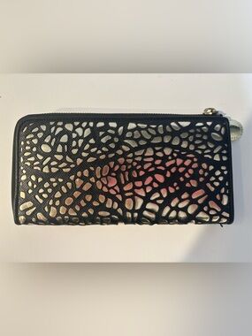 Ivanka Trump continental zip-around wallet featuring a signature laser-cut geome